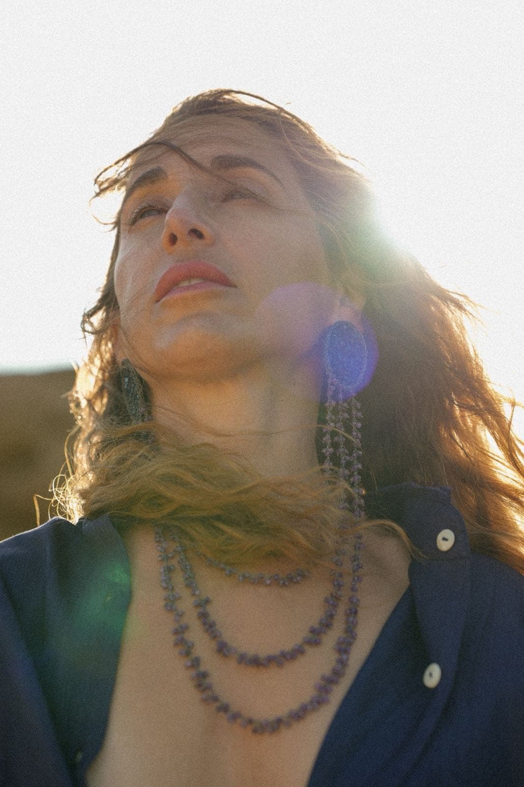 My face turned up into the sun, a flare of light across the frame.